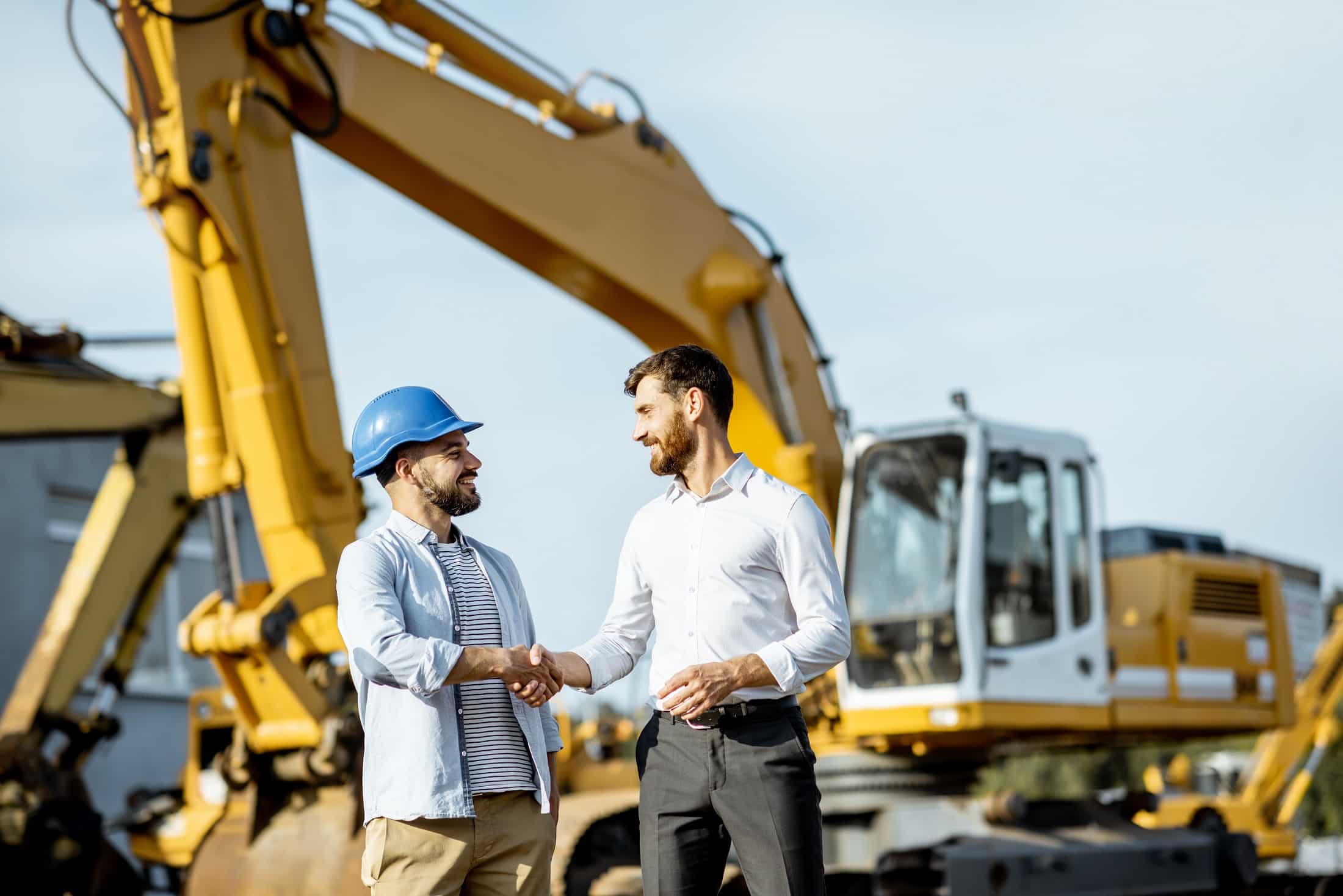 Handshake in front of crane